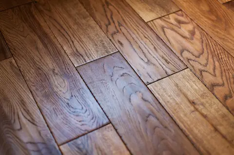 Diagonal hardwood floor planks in warm brown tones with natural wood grain patterns and subtle color variation.