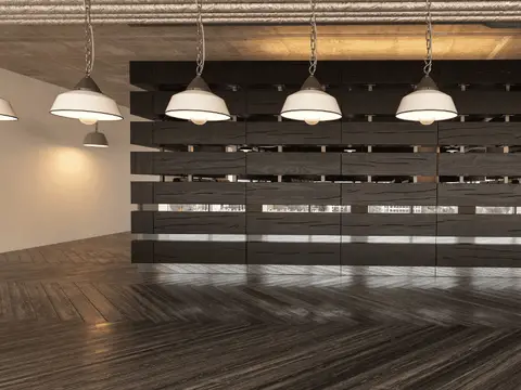 Spacious commercial interior with herringbone wood flooring, four pendant lights with white domes, and full-width storefront